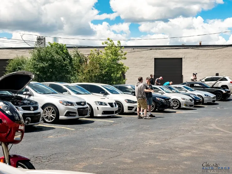 A row of cars are parked in a parking lot.