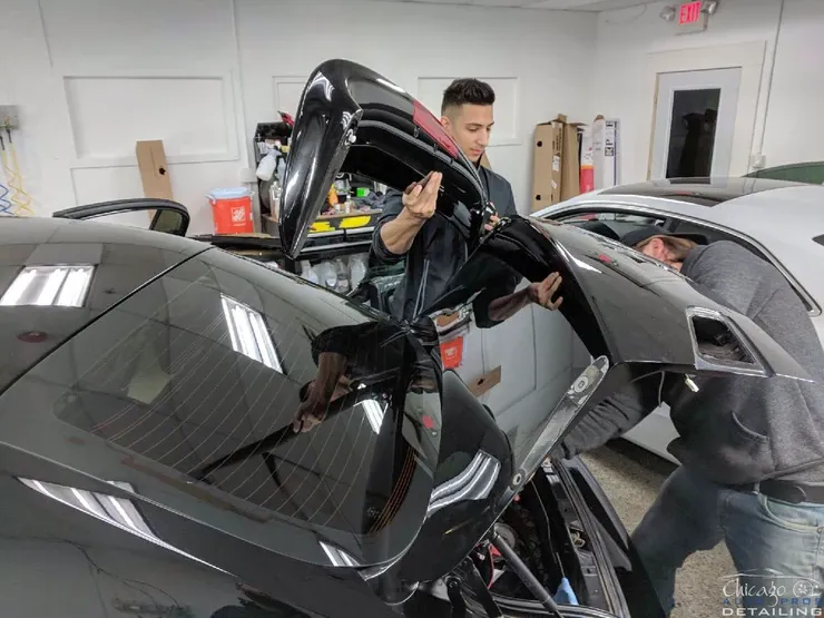 A man is working on a car in a garage.