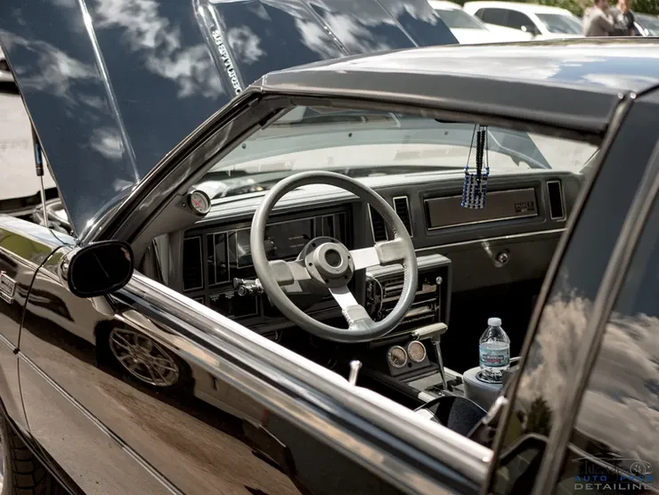 The inside of a black car with the hood open