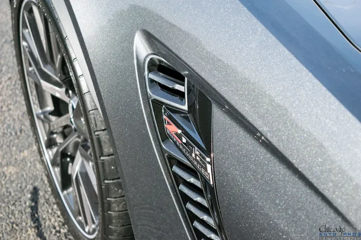 A close up of the side of a gray car