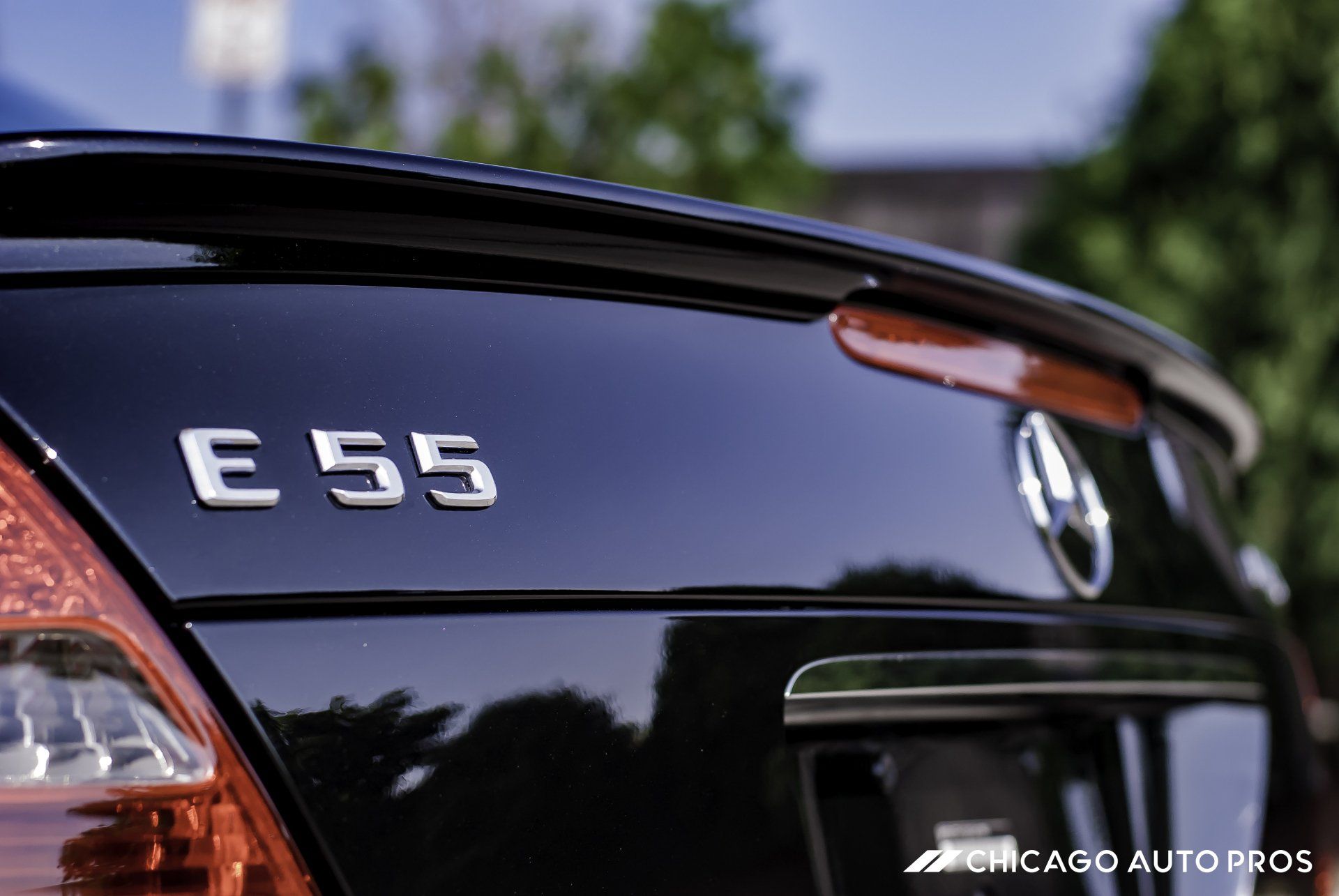 A black mercedes e55 is parked in a parking lot