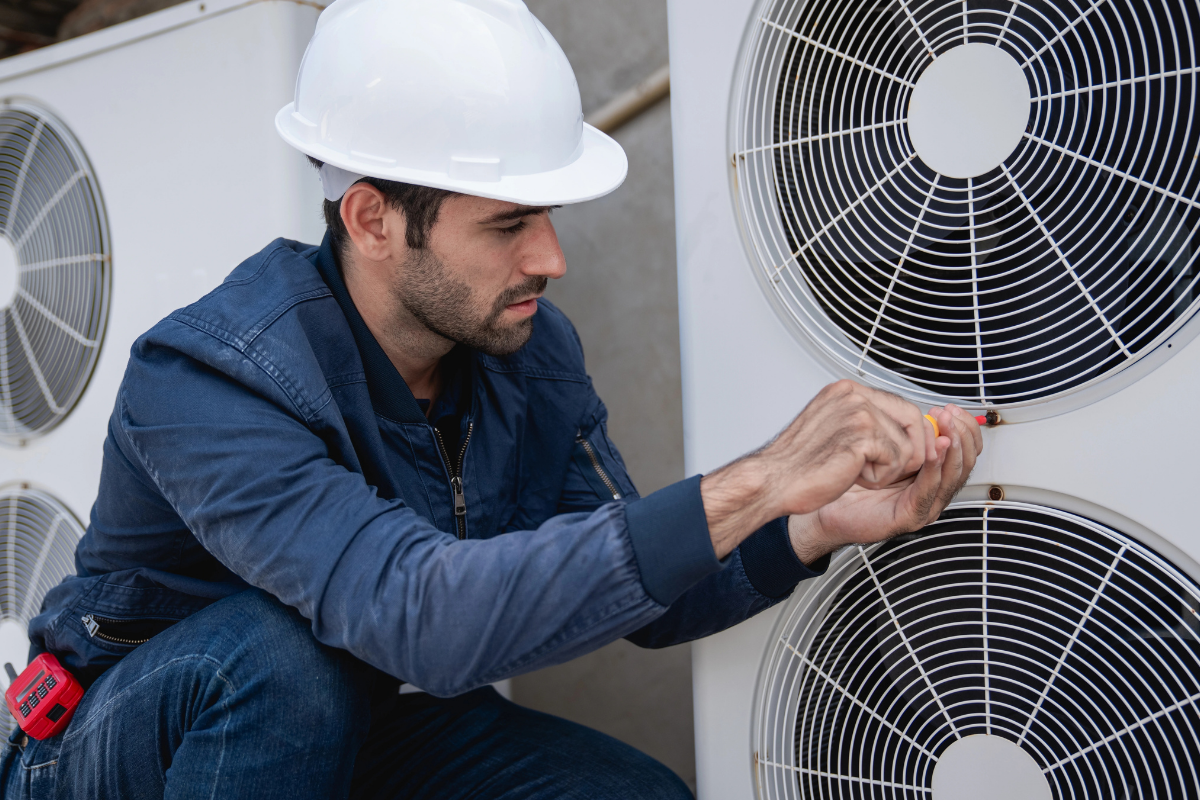 Professional NATE certified contractor putting the final touches on a newly installed heat pump in Denver
