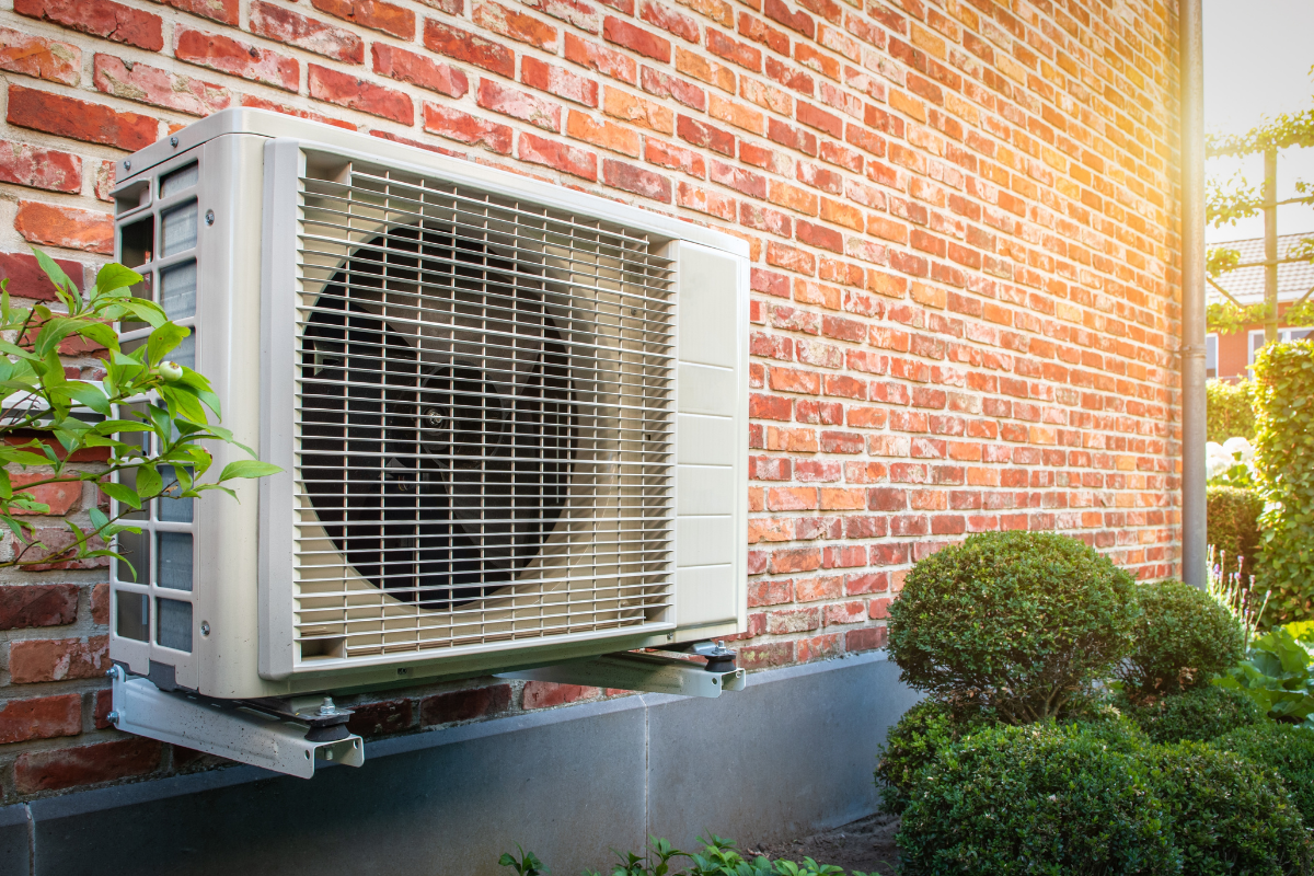 Efficient heat pump installed outside brick home in Denver, CO