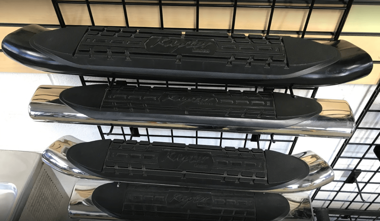 Three skateboards are sitting on top of each other on a shelf.