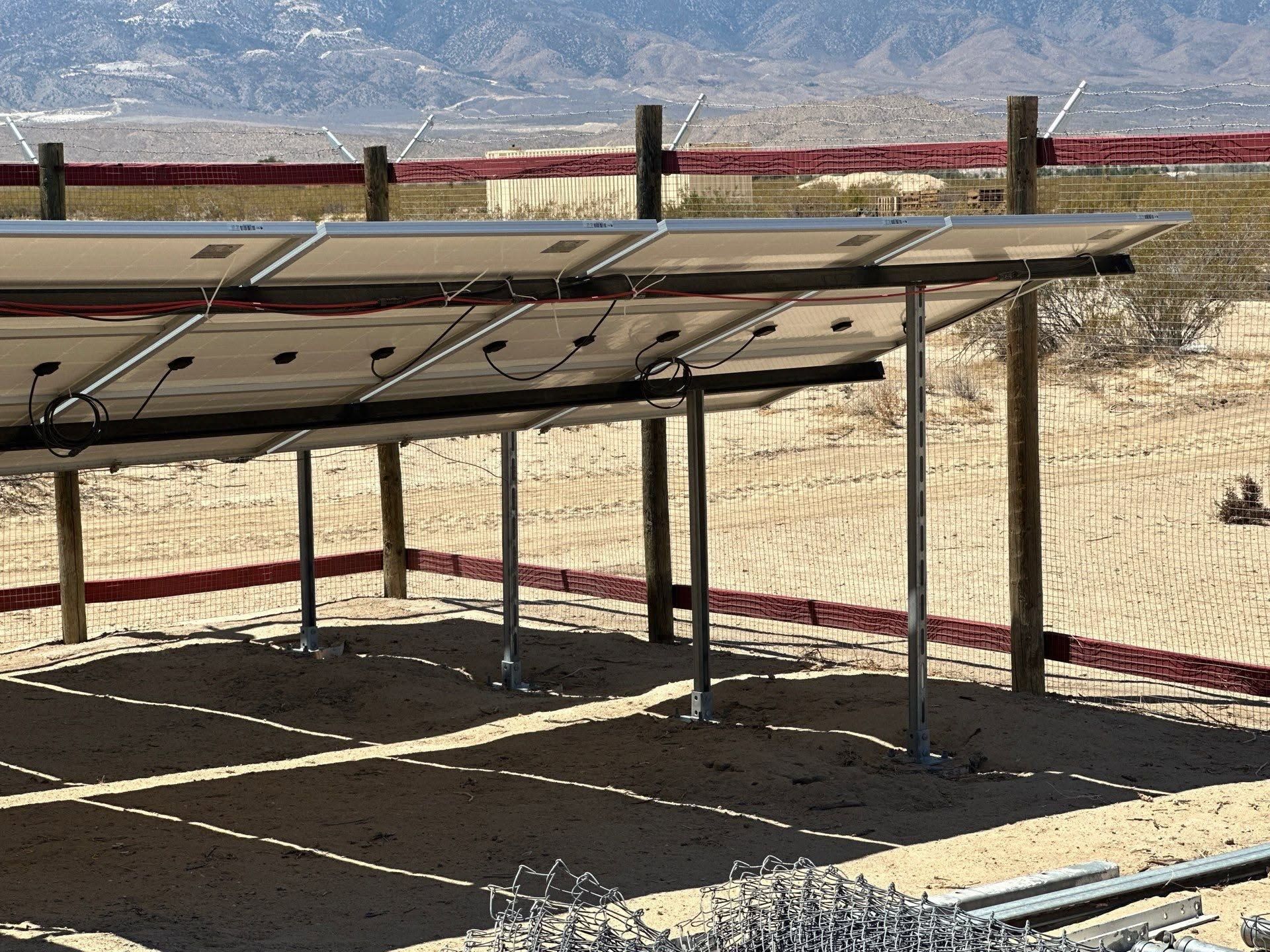 Solar panel canopy with metal frame in a dry outdoor desert setting