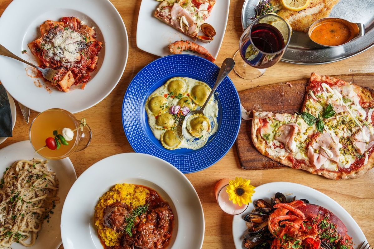 Table full of Italian dishes from Romanissimo Italian restaurant in San Diego. 