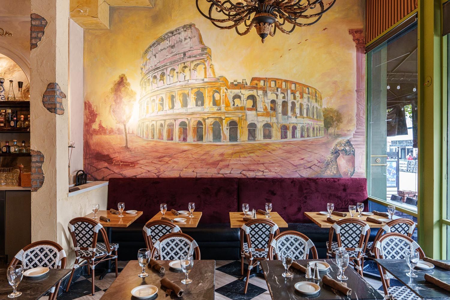Dining space with Roman Colosseum wall mural. 