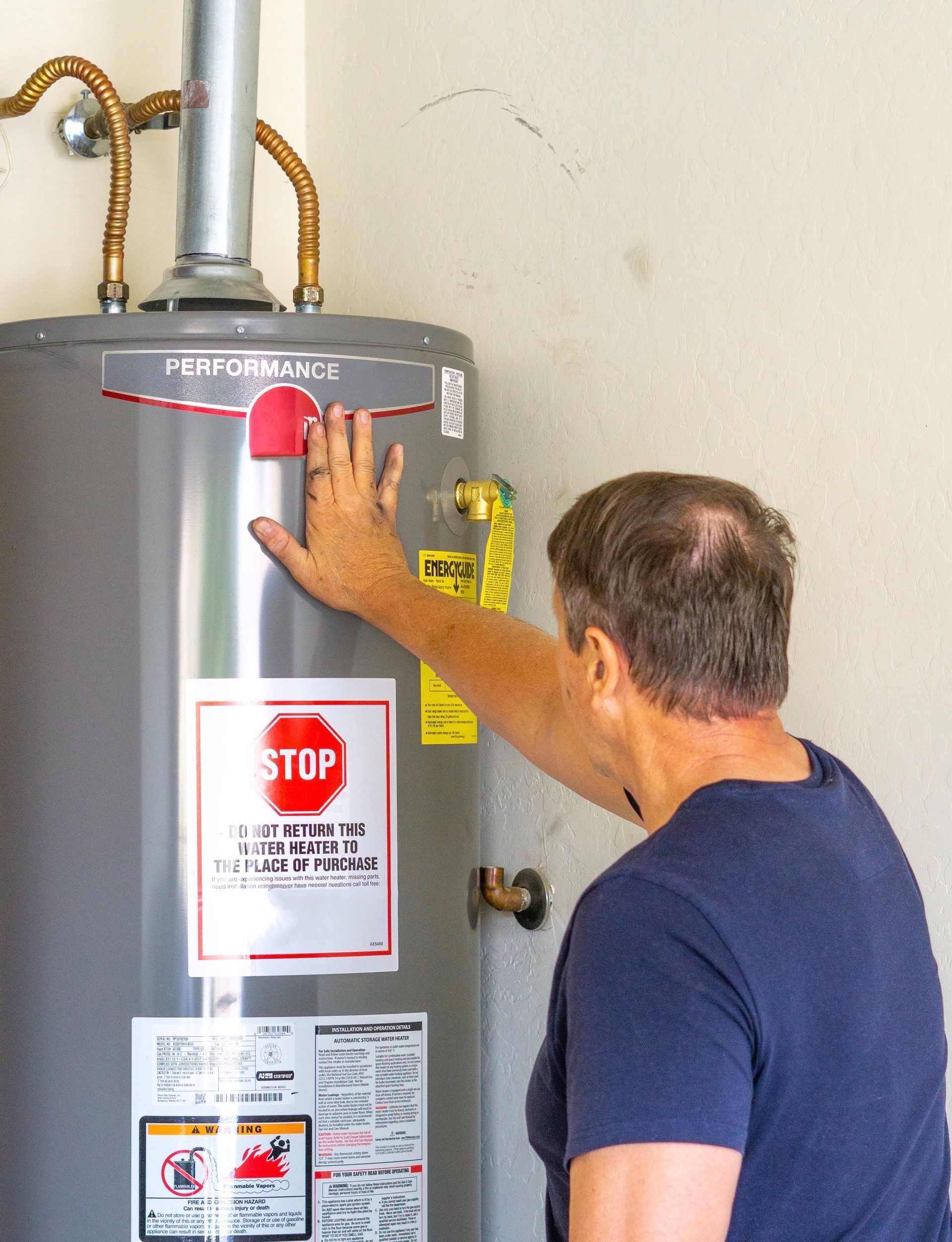 plumber fixing string noises coming from water heater