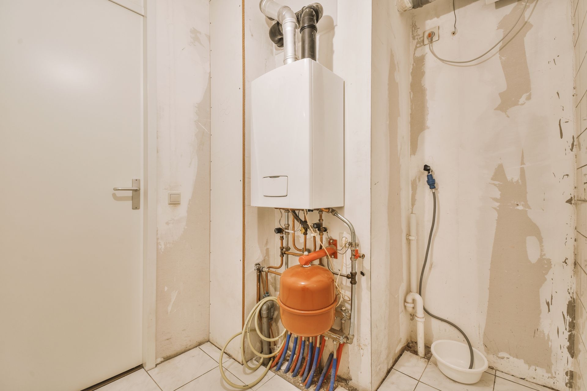 There is a boiler in the corner of the room.