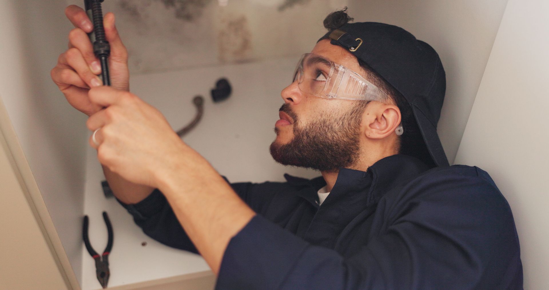 plumber fixing bathroom sink 