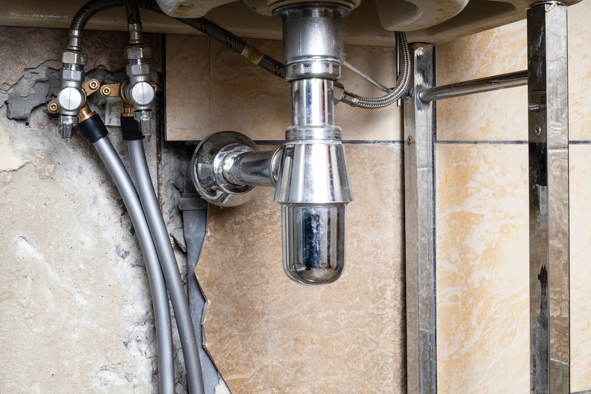 A sink with a drain pipe underneath it