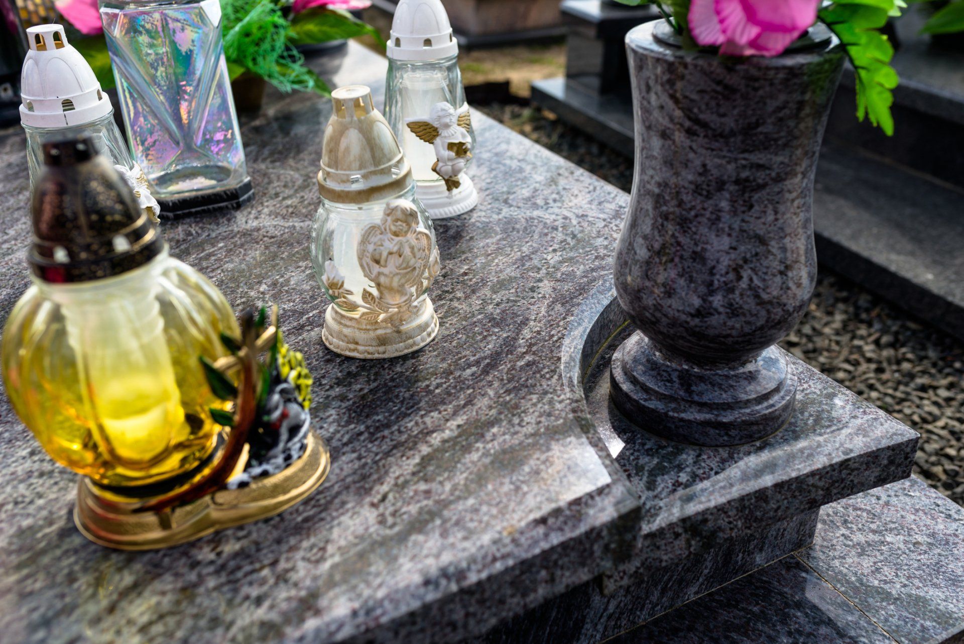 Flats — Candlesticks and a Vase with Flowers Lying on a Flat Dark Marble Tombstone in Greely, CO