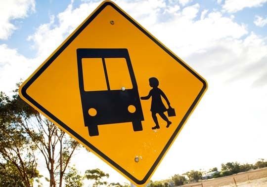 Yellow Sign with a Silhouette of a Child Standing Next to a Bus — Swan Hill, VIC — BusBiz