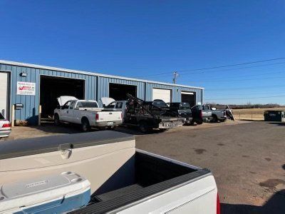 A row of trucks are parked in front of a building.