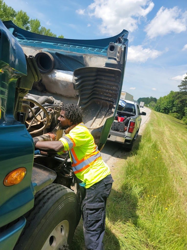 Car repair shop interior with vehicles on lifts, stacked tires, and tools.