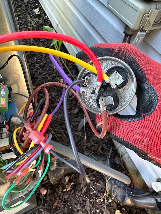 A bunch of wires are laying on the ground next to a house.