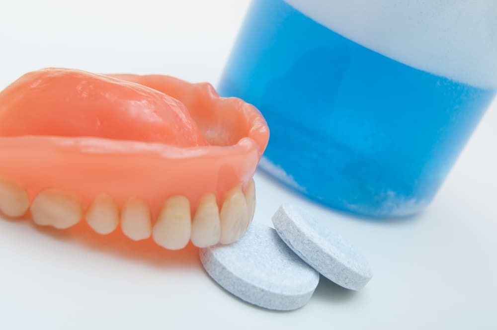Denture Using A Water Glass And Cleaning Tablets - Dentures in Mittagong, NSW