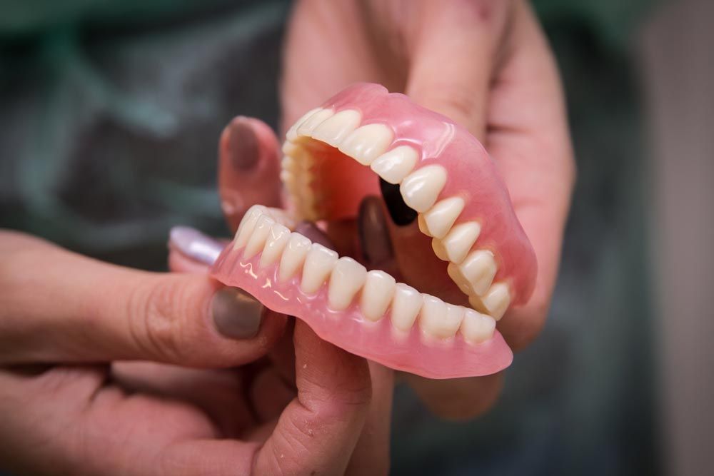 Dentist Holding Dentures