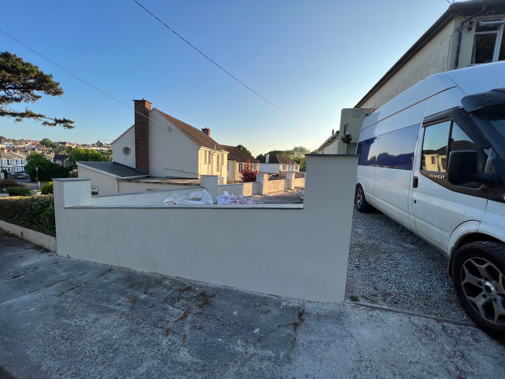 A white van is parked in front of a house.
