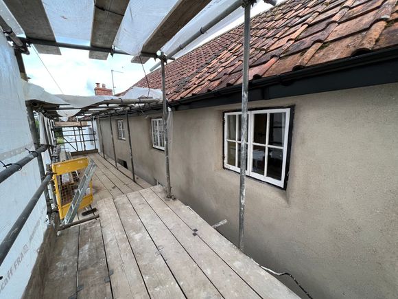 A scaffolding is being built on the side of a building.