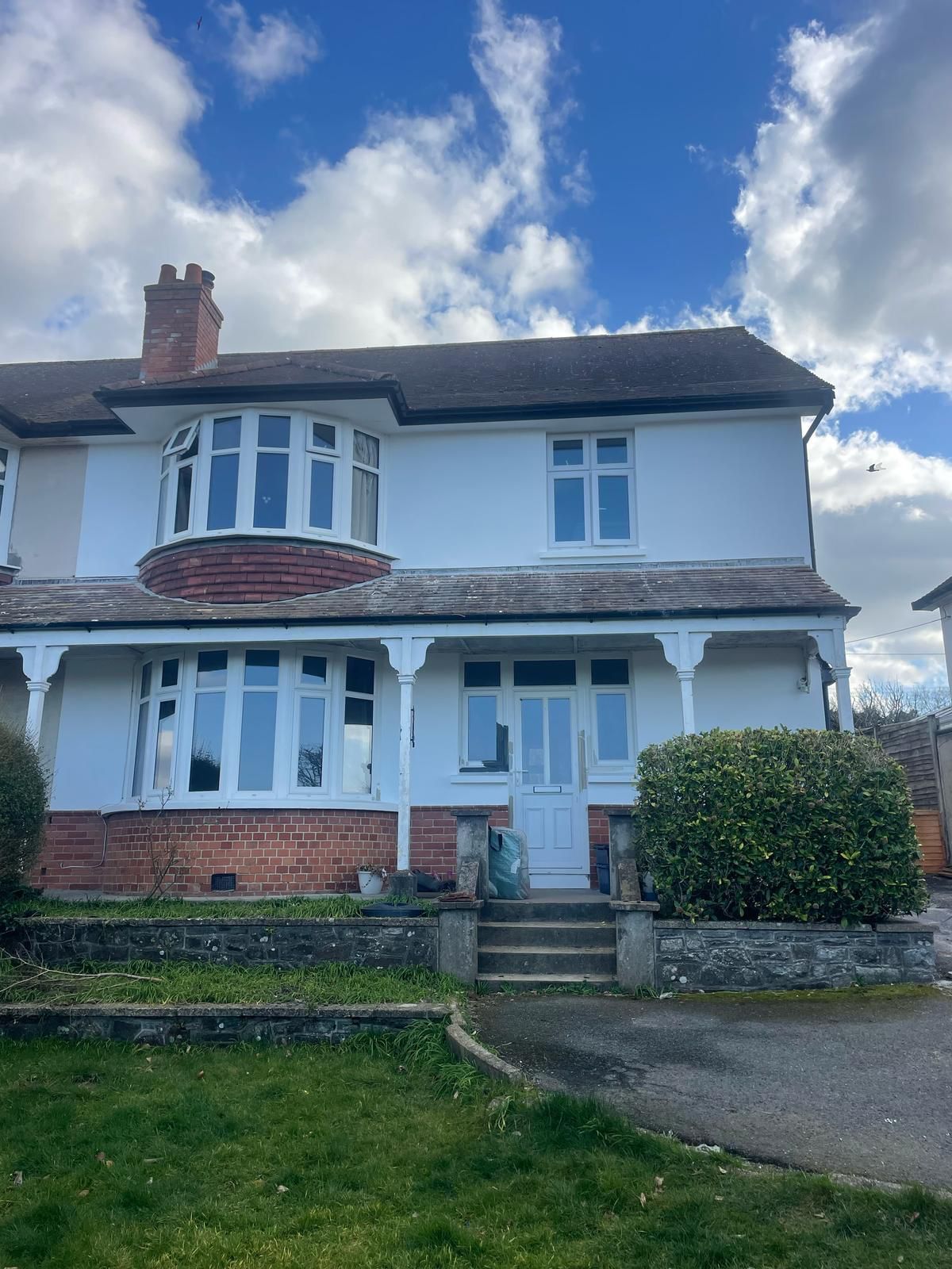 An empty room with a window and a box on the floor.