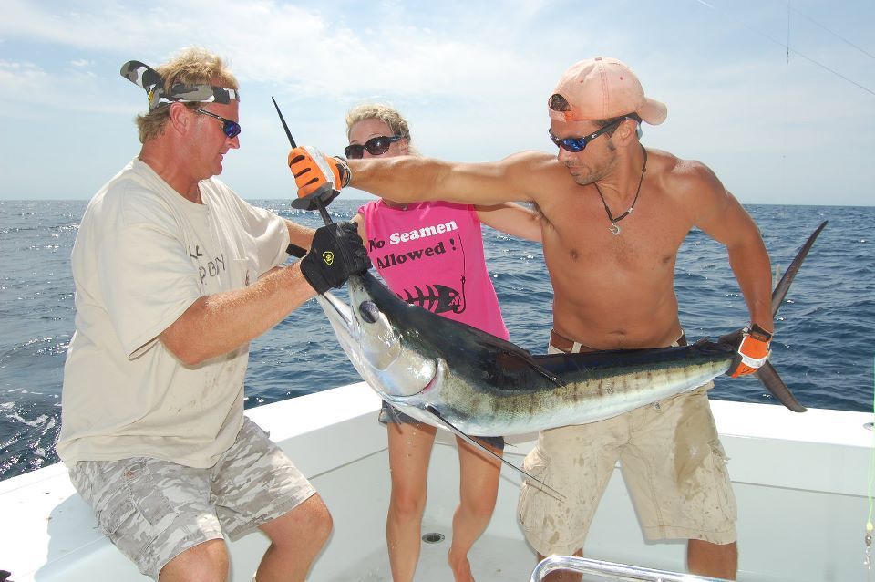 Captain Steve and Charter Anglers holding a Blue Marlin they caught off shore fishing
