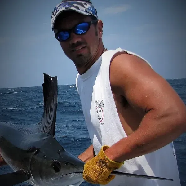 Captain Steve holding a great catch of a Marlin