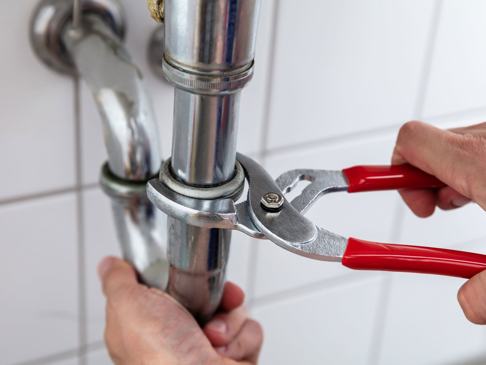 Professional Plumbing — Plumber Repairing Kitchen Sink in Pittsburgh, PA