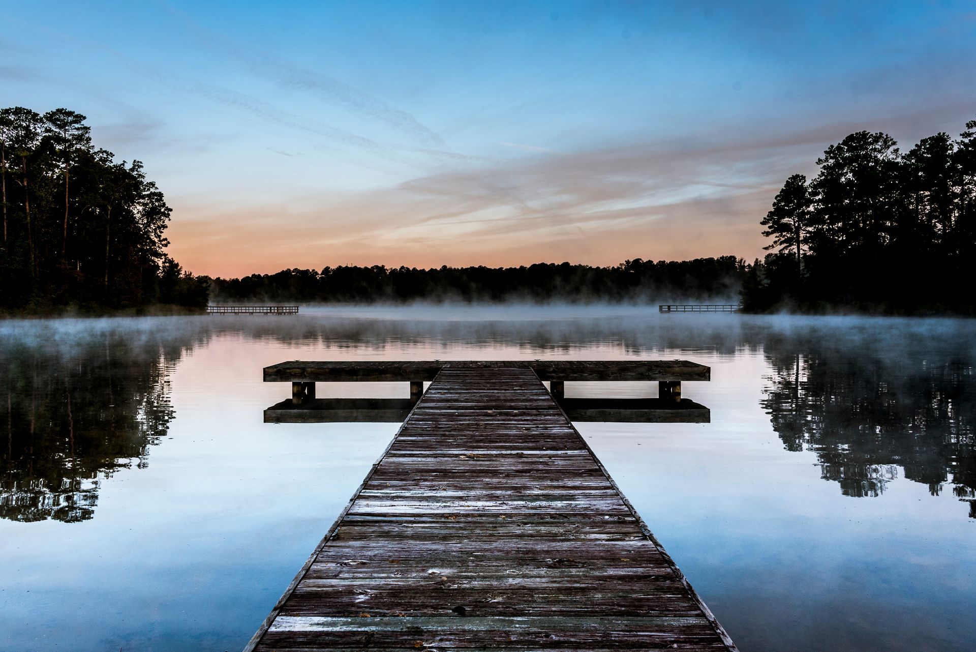 a wooden dock leading into a lake at sunrise.  Talking Excitingly, Brad Burgess Photography