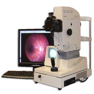 An Elderly Man is Getting His Eyes Examined by an Ophthalmologist — Michael Chu Optometrist in Cairns North, QLD