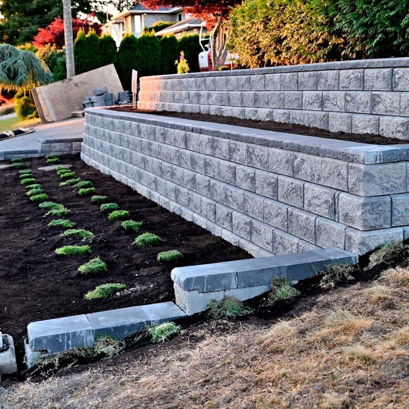 A brick wall with a planter in the middle of it