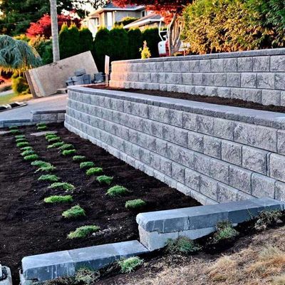 A brick wall with a planter in the middle of it
