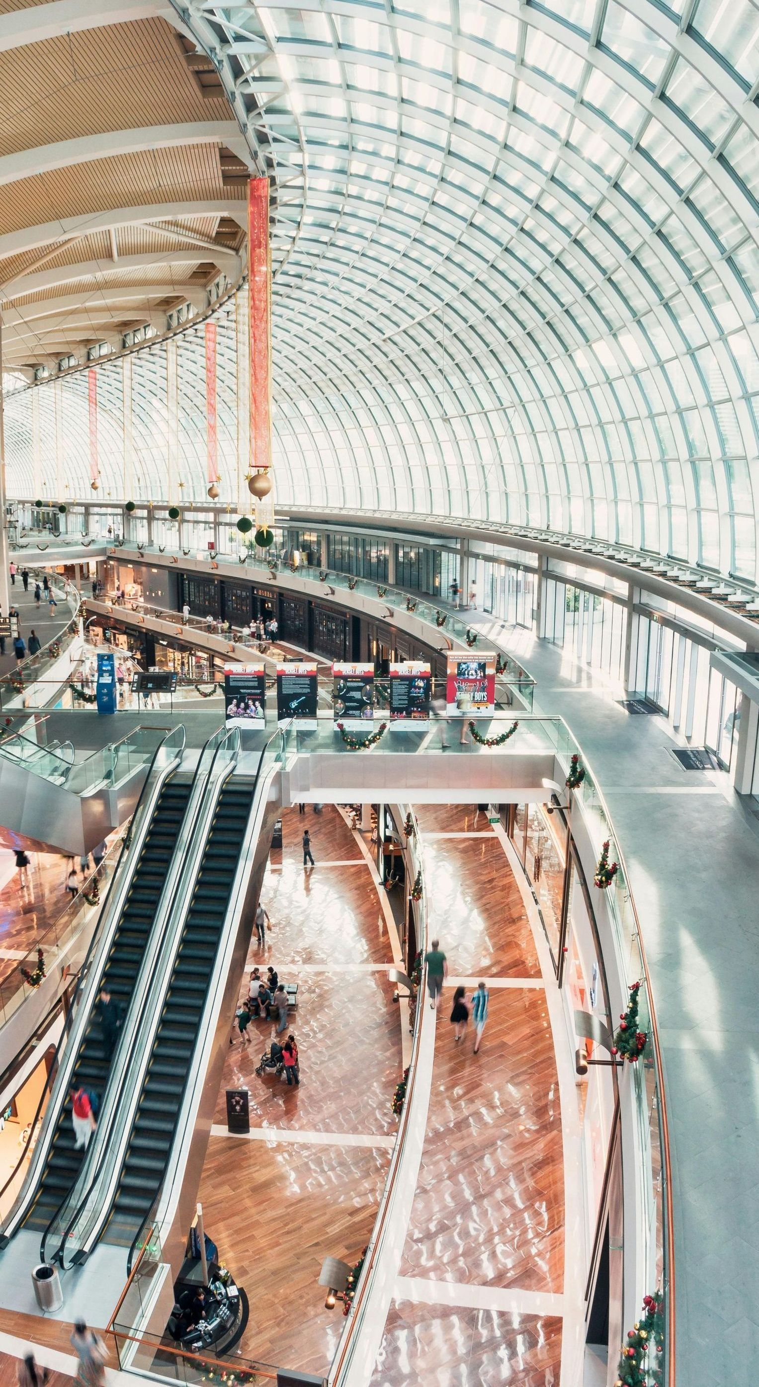 An aerial view of a shopping mall with escalators going up and down.