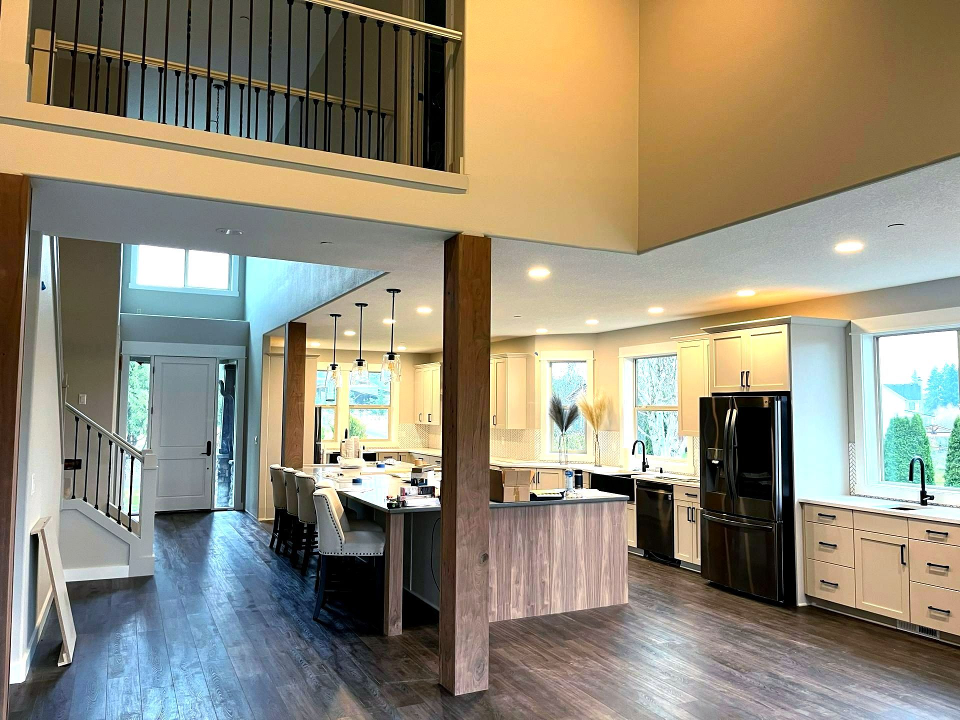 Beautiful modern kitchen area with wood floors and freshly painted cabinets