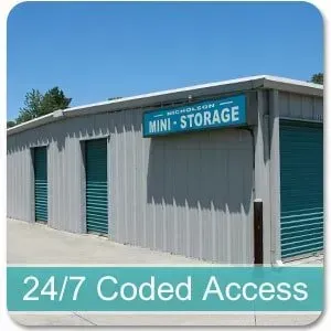Sign for Nicholson Mini Storage and Salon, blue and white, with storage units in background.