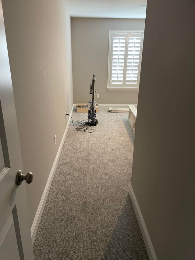 There is a vacuum cleaner in the middle of the room.
