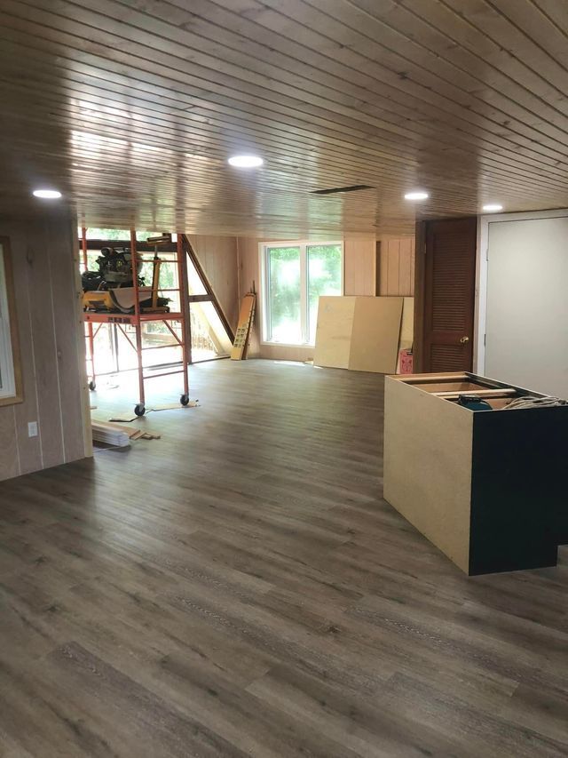 A large room with wooden floors and a wooden ceiling.