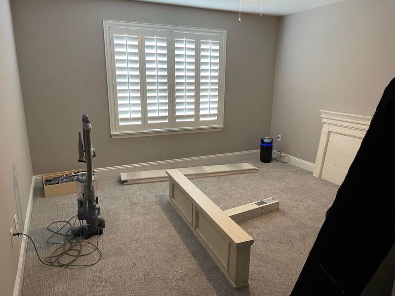 A room with a vacuum cleaner and a television in it