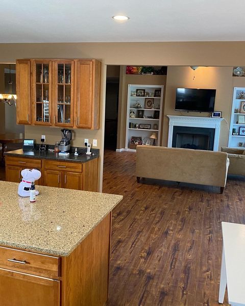 A kitchen with wooden cabinets and granite counter tops