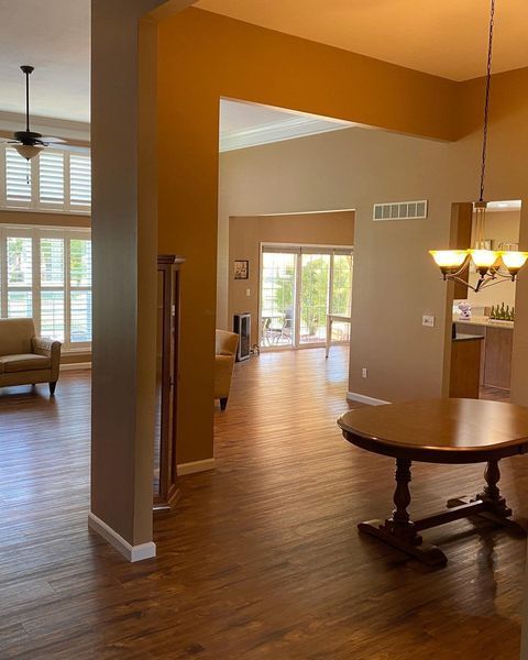 A living room with hardwood floors and a round table