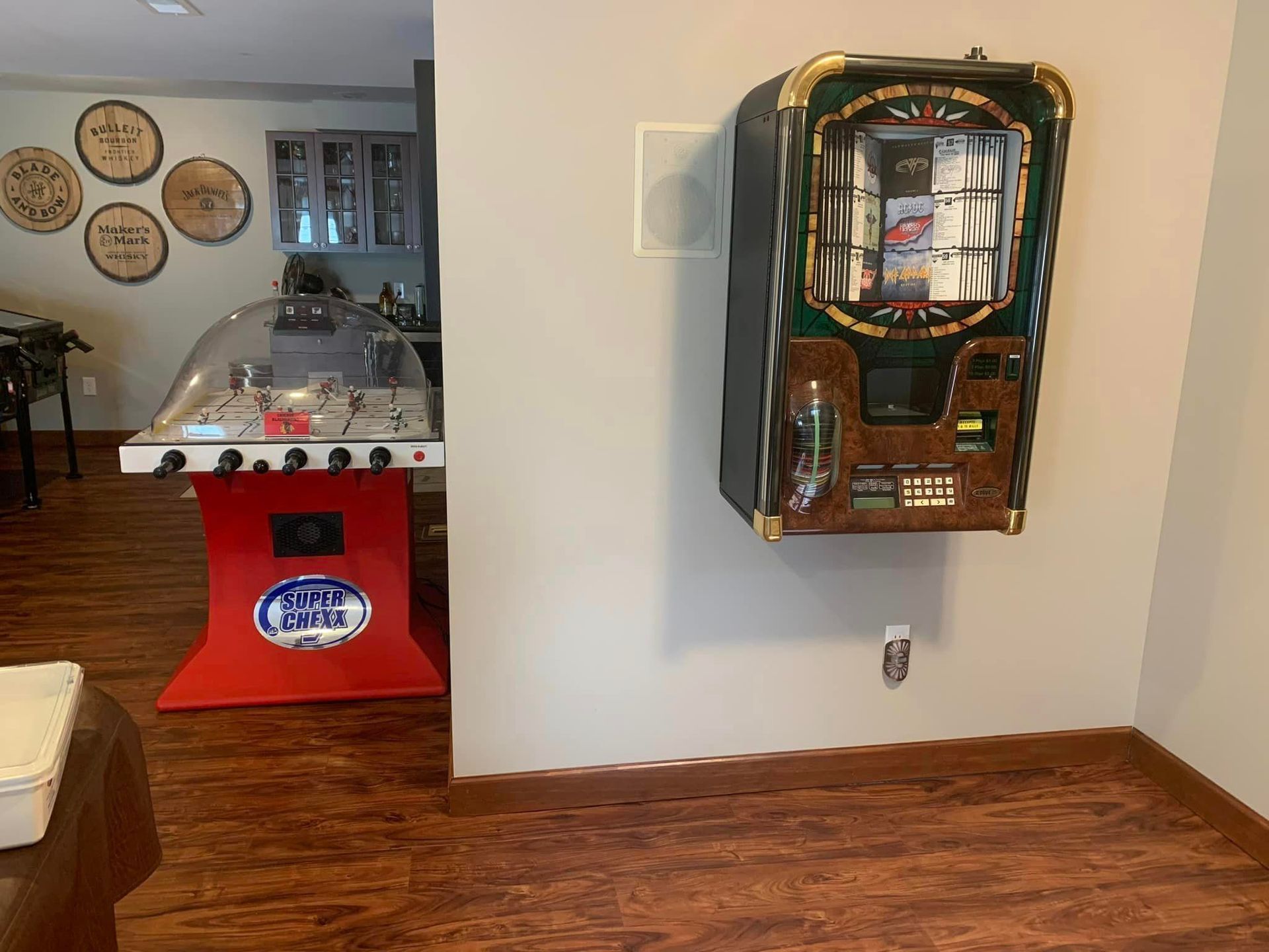 A room with a table and a machine on the wall