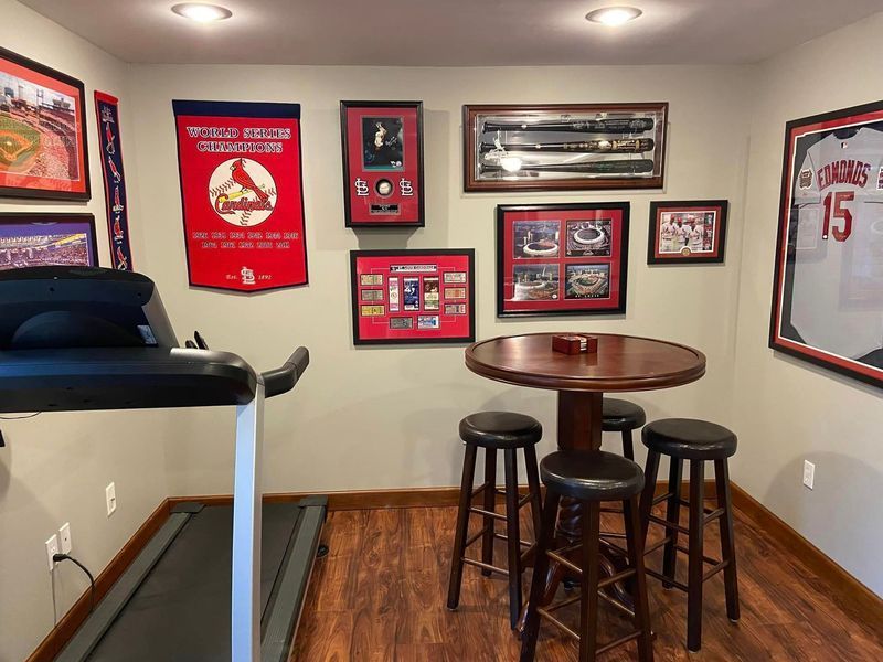 There is a treadmill in the room with a table and stools.