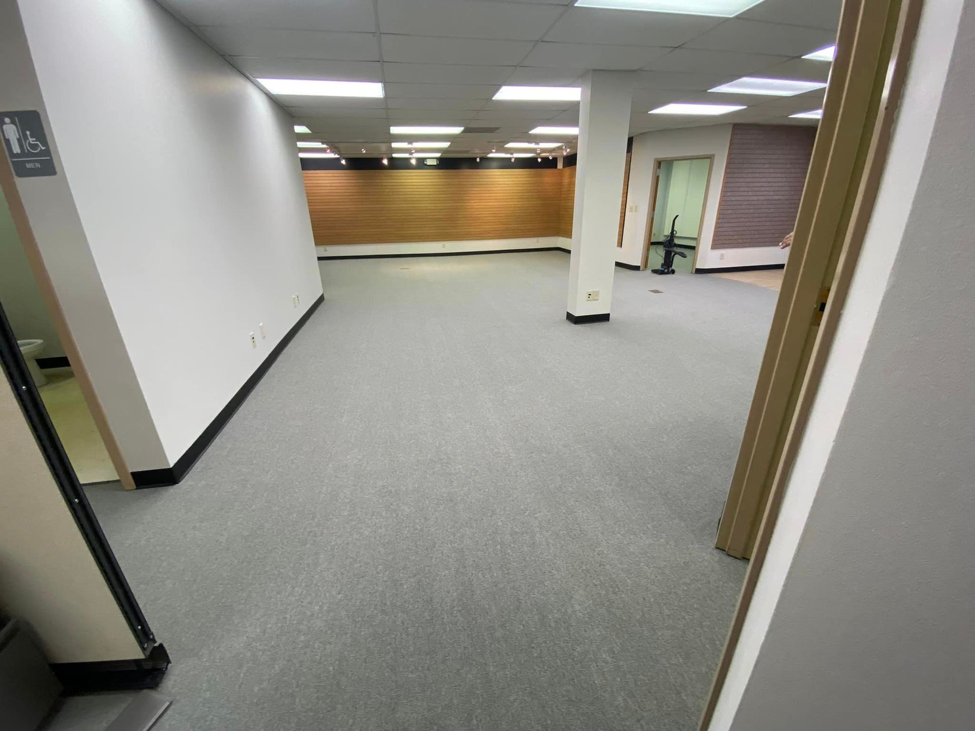 An empty room with a handicapped sign on the wall