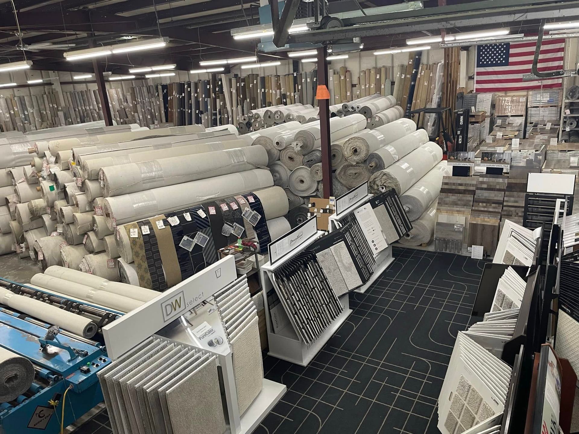 A large warehouse filled with lots of carpets and rugs.