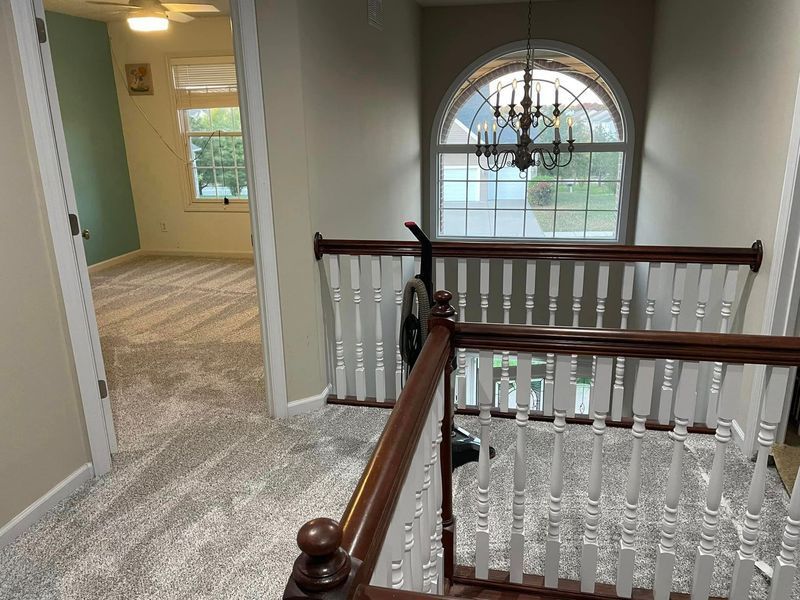 A view of a staircase from the second floor of a house.
