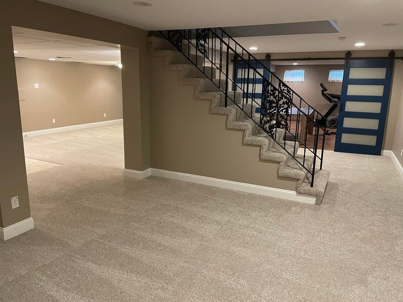 A basement with a staircase leading up to the second floor.