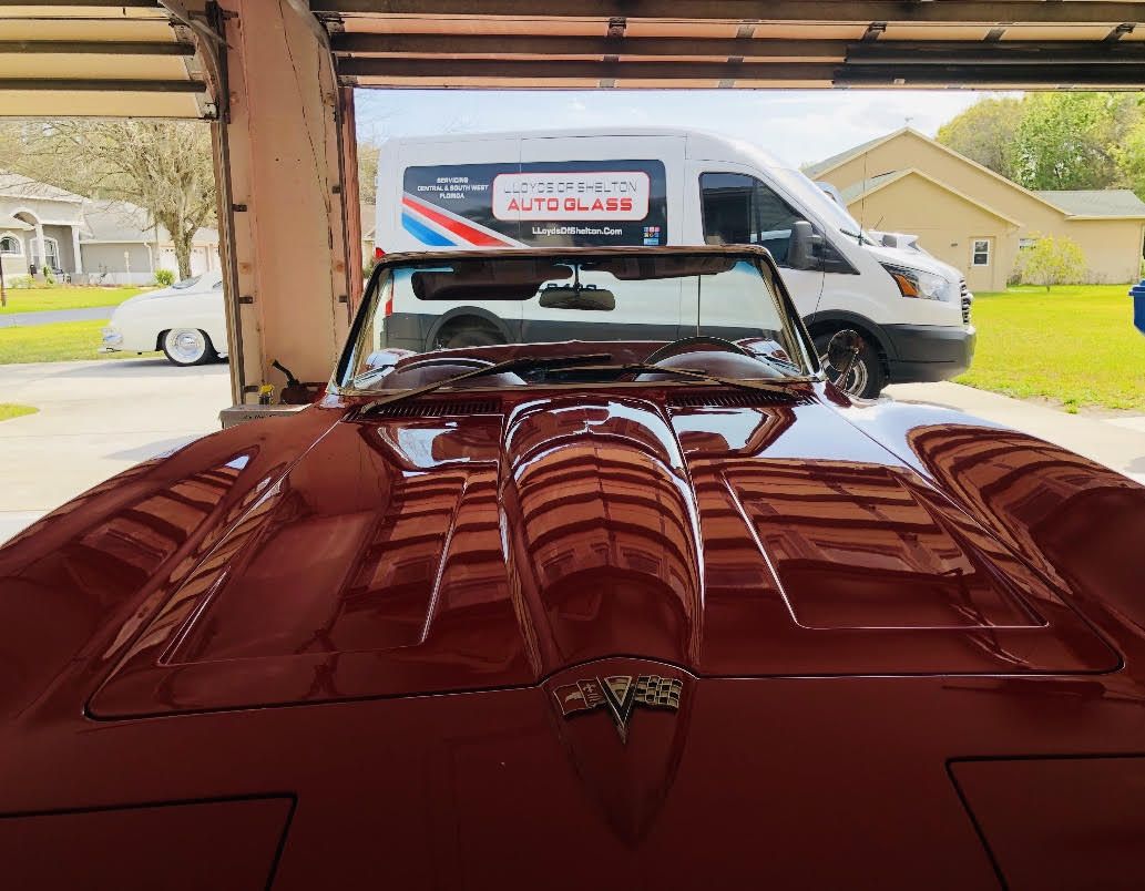 Red convertible with Lloyd's of Shelton van in the background