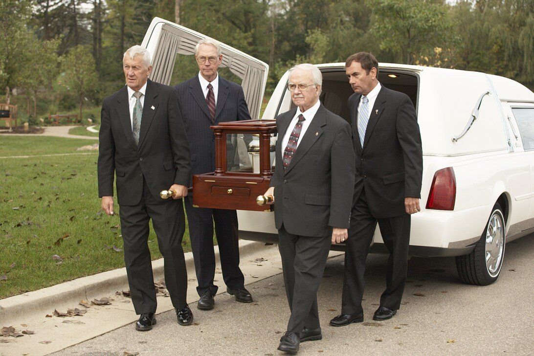 Four men carrying the funeral ark