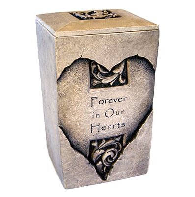 Square stone urn with heart engraved on front