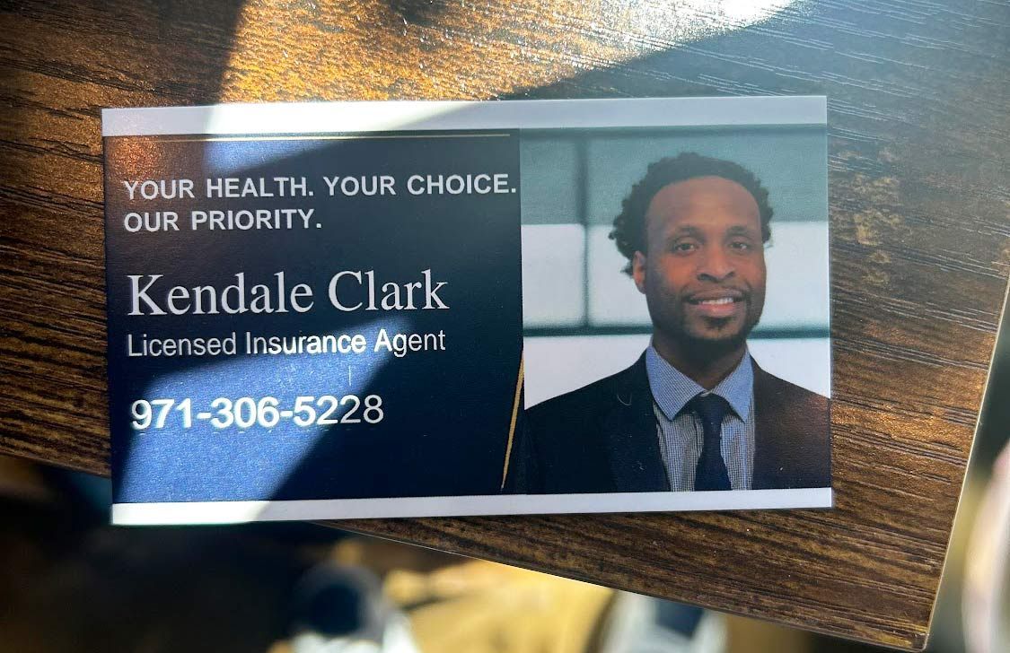 Business card for Kendale Clark, licensed insurance agent. Photo of Clark in a suit. Contact info listed.